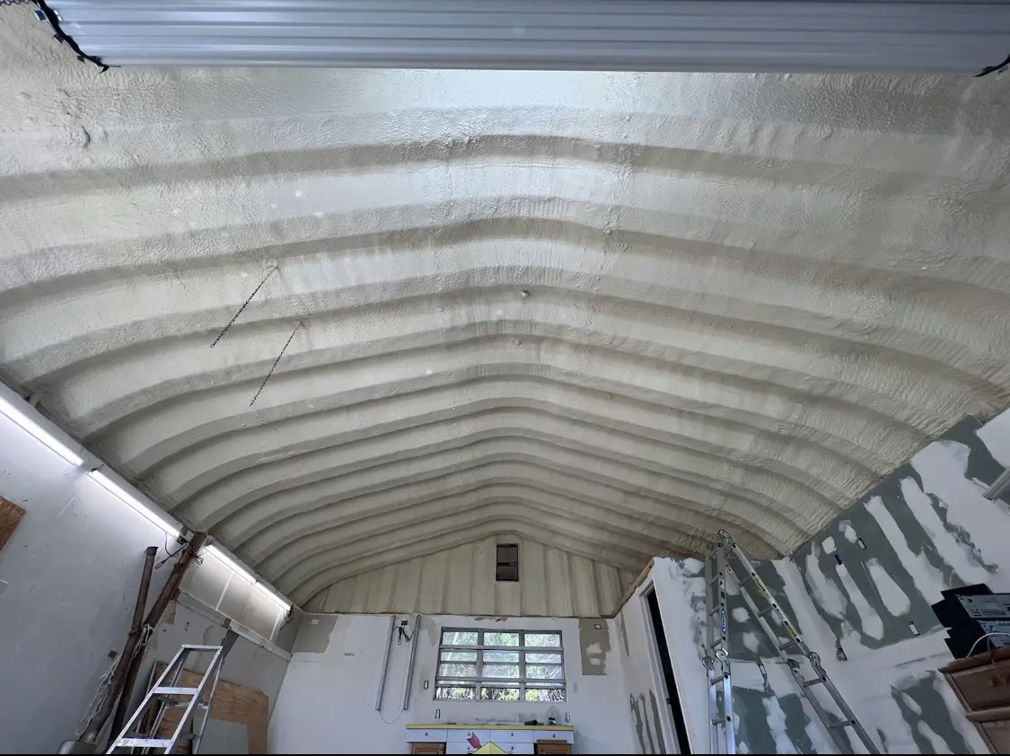 Spray polyurethane foam applied to the underside of a metal roof deck in Beekman